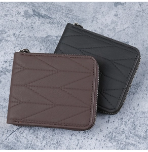 Detail of black and brown short wallets with geometric quilted stitching and zippers