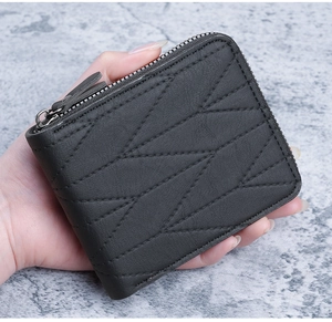 Close-up of black men's short wallet with geometric stitching and dual zippers
