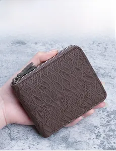 Macro detail of men's coffee brown wallet with feather texture and L-shaped zipper