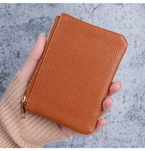 L-shaped zipper detail on brown pebble leather card holder with gold hardware