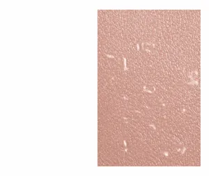 Close-up of pink litchi grain leather texture and durable stitching on a compact wallet