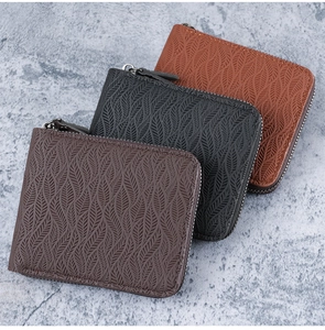 Three multi-slot zip wallets featuring embossed texture in brown, black and tan leather