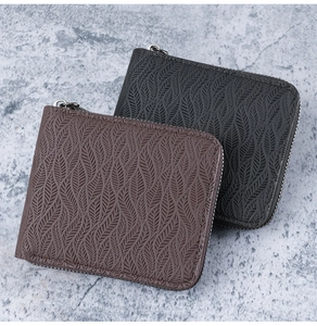 Detail showing vintage leaf-embossed leather texture on brown and black men's wallets