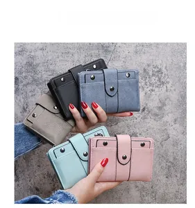 Mini matte leather wallets with rivets and zipper closure shown in various candy colors