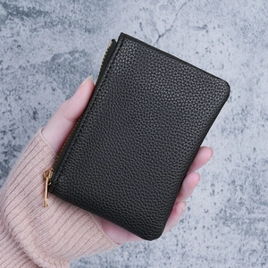 Minimalist black pebble leather compact wallet with golden L-shaped zipper
