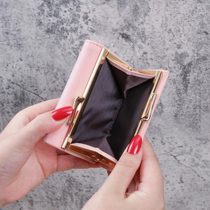 Pink short multi-functional wallet with gold metal clasp and interior compartments
