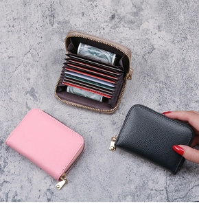 Detail of accordion card slots in pink, black, and beige lychee texture leather wallets