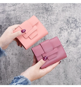 Detail of pink lychee grain leather mini wallets with stitching and snap closure