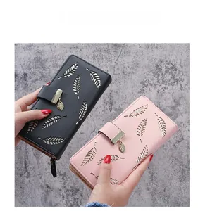 Detail of leaf cut-out design on PU leather long wallets in black and pink colors