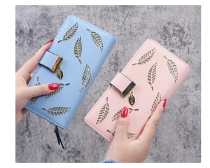 Close-up of light pink and blue PU leather wallets featuring hollow leaf patterns