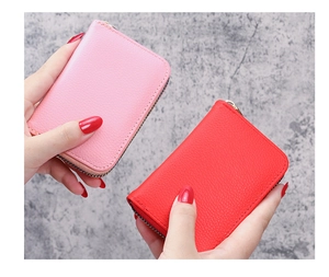Detailed view of pink and red lychee texture card holders with secure metal zippers