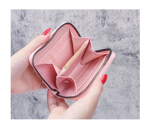 Internal view of pink PU leather wallet with accordion slots and zippered coin compartment