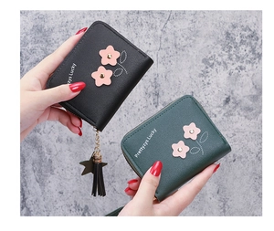 Detailed shot of leather wallet showing floral applique and star tassel zipper pull