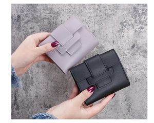 Close-up of portable tri-fold wallets in lavender and black with pebbled faux leather