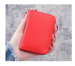 Close-up of a red lychee texture leather credit card wallet with a secure zipper closure