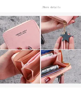 Detail view of pink women's wallet with star charm, tassel, and multi-card slots