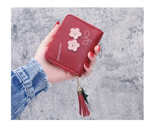 Close-up of a red short floral PU leather wallet with fringe and star zipper pull charms