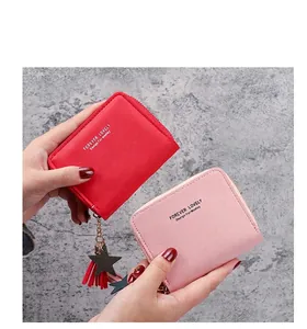 Detailed shot of mini PU leather wallets with star charms and decorative tassels
