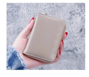 Close-up of litchi grain leather card holder with U-shaped zipper in elegant grey