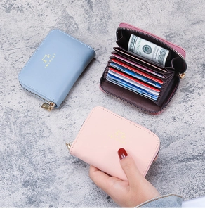 Detail of multi-slot organ card holders with cat motif in pink and blue faux leather