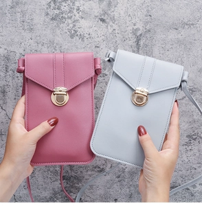 Close-up of PU leather crossbody phone bags with gold buckles in pink and light blue