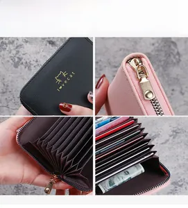 Detail of accordion card holder showing pebble leather texture and gold metal zipper