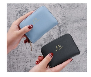 Detail of mini cat logo card holders in light blue and black with gold cat print and zipper