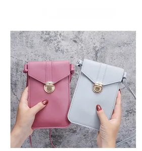 Detailed view of pink and grey PU leather phone bags with gold metallic buckles