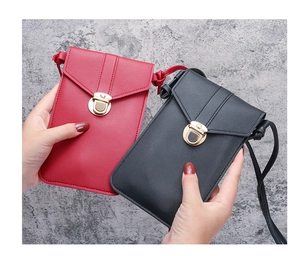 Detail view of red and black PU leather mini crossbody bags with gold metal clasps