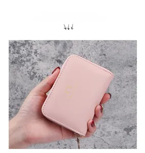 Close-up of pink PU leather cat wallet with gold Love Cat logo and secure zipper closure
