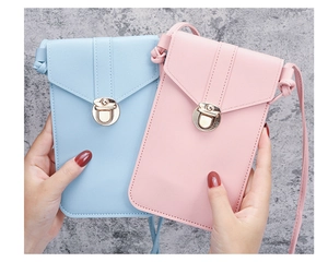 Detail of PU leather phone bag with round gold metal lock and fine stitching