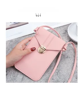 Close-up of pink PU leather crossbody phone bag with gold metal clasp and pebble texture