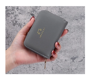 Detail of dark grey leather card holder with gold cat print and love cat text