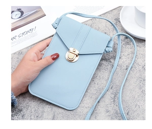 Detail of light blue PU leather phone crossbody bag with round gold metal clasp