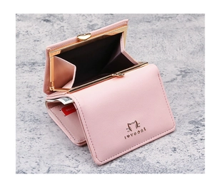 Detail view of pink trifold wallet with gold cat logo and metal kiss-lock coin pocket