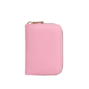 Pink litchi texture card holder wallet with golden zipper on a white background
