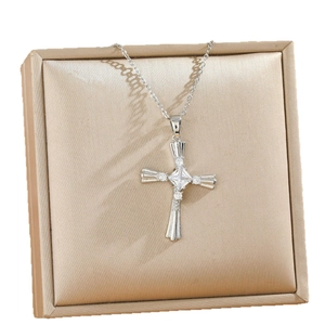 Silver cross necklace with square center stone and snake wrap design on champagne satin