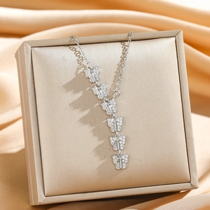 Sparkling butterfly tassel pendant necklace with silver micro-set rhinestones on jewelry box