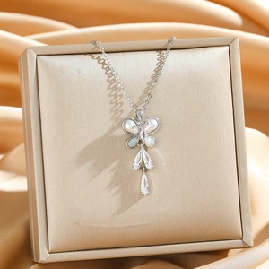 Elegant silver butterfly necklace with white pearls, opals, and sparkling zircon tassels
