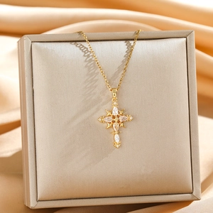 Elegant gold cross star pendant necklace with zircons on a luxury silk background