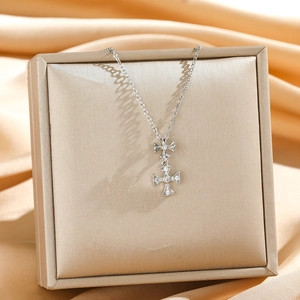 Macro view of double cross pendant necklace with sparkling diamonds in a luxury jewelry box