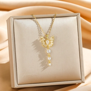 Elegant gold titanium necklace featuring a sparkling butterfly pendant with tassels