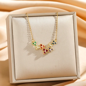 Elegant gold flower necklace with colorful zircon stones on champagne silk background