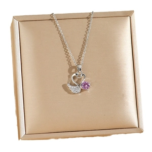 Collier avec pendentif cœur de cygne rose et zircons sur un support en soie élégant