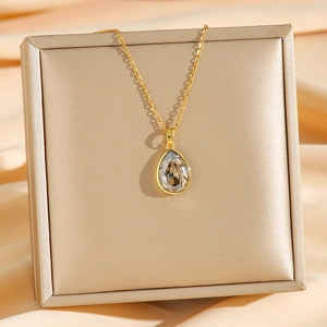 Elegant gold titanium steel necklace with a teardrop violet crystal pendant on a silk box