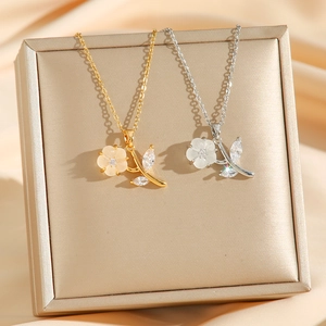 Elegant gold and silver floral necklaces with matte white petals and cubic zirconia leaves