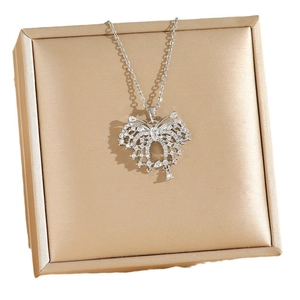 Elegant silver butterfly necklace with sparkling zircon pavé on a gold satin jewelry box