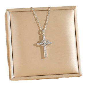 Elegant silver cross pendant necklace with intertwined hearts and cubic zirconia stones