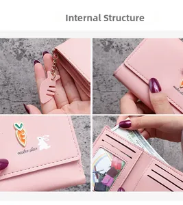 Detail view of pink Easter wallet showing card slots and cute carrot pendant