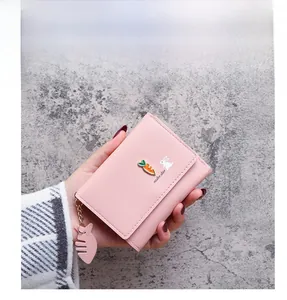 Pink short PU leather wallet with cute rabbit motif and carrot charm detail